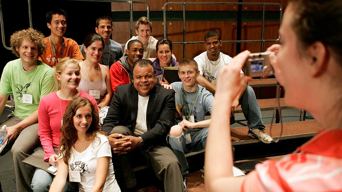 Stangeland Family Youth Choral Academy Director Anton Armstrong having his photo taken with students participating in the academy