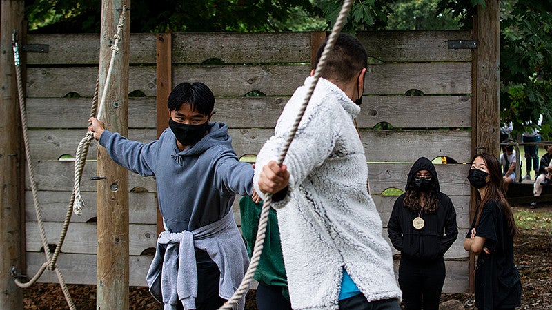 students on a low ropes course