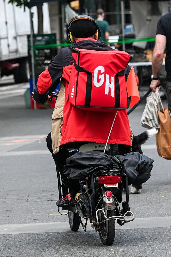 Food delivery driver on moped