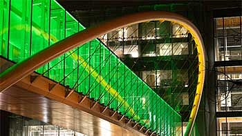 The Knight Campus skybridge lit up in green and yellow