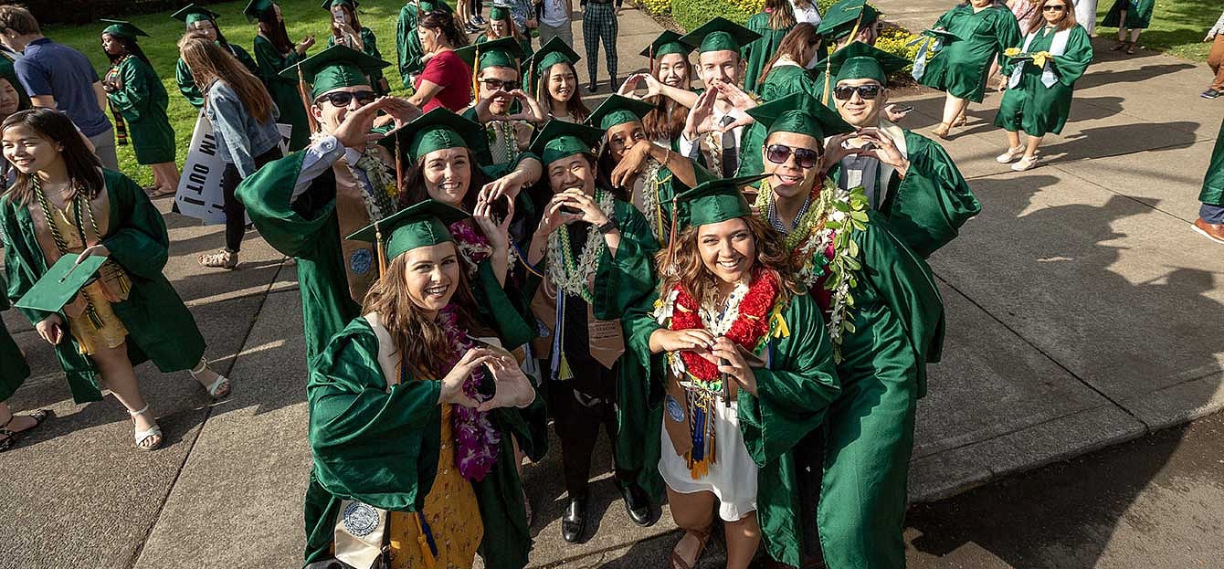 Ducks throw their O in front of Johnson Hall before the Grad Parade Ducks throw their O in front of Johnson Hall before the Grad Parade