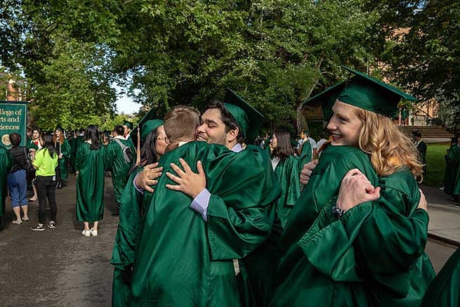 Students hug each otheStudents hug each other as they celebrate graduating and the time they spent togetherr as they celebrate graduating and the time they spent together Students hug each other as they celebrate graduating and the time they spent together