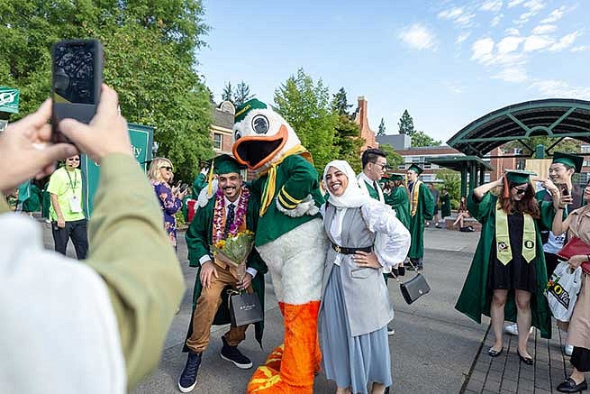 Students are always excited to pose with the Duck, especially on graduation day Students are always excited to pose with the Duck, especially on graduation day