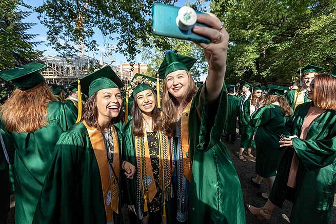 Students take a moment to get a selfie before parading down 13th avenue toward Matt Knight Arena Students take a moment to get a selfie before parading down 13th avenue toward Matt Knight Arena