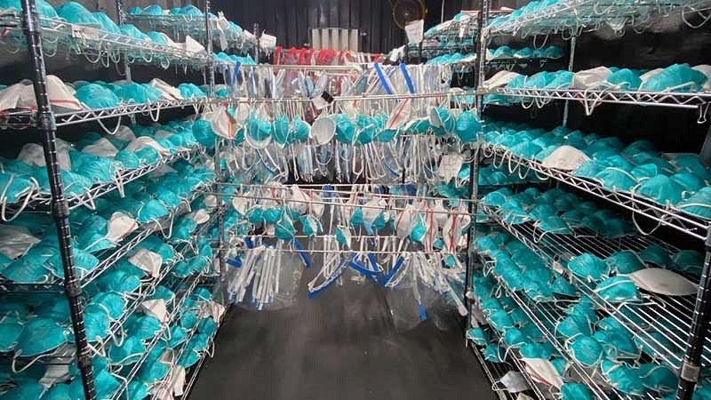 Over the past year, the UO has been in the forefront of community efforts to find and contain the coronavirus that causes COVID-19, including hosting a facility for cleaning N95 masks. Rows of N95 masks hanging on racks
