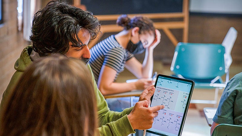 Students looking at a tablet in a CHC classroom.  Photo credit: Jasper Zhou