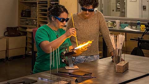 Daniela Cárdenas-Riumalló manipulating glass with a torch