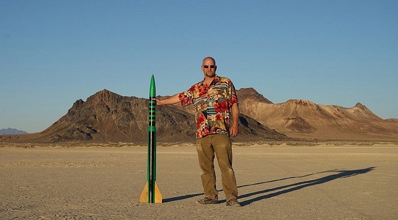 Science librarian Dean Walton with green and yellow rocket.