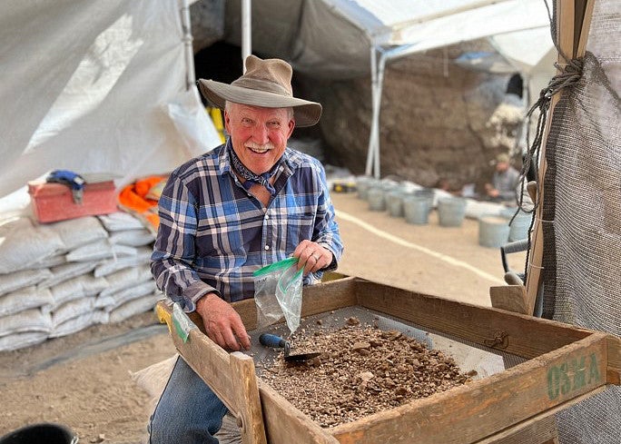 Dennis Jenkins of the Museum of Natural and Cultural History sorting soil samples in a screen.