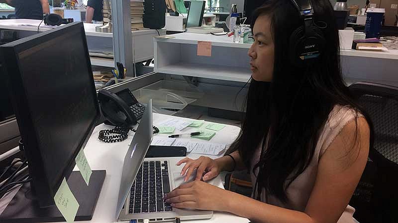 Kaylee Domzalski with headphones working at a computer Kaylee Domzalski with headphones working at a computer