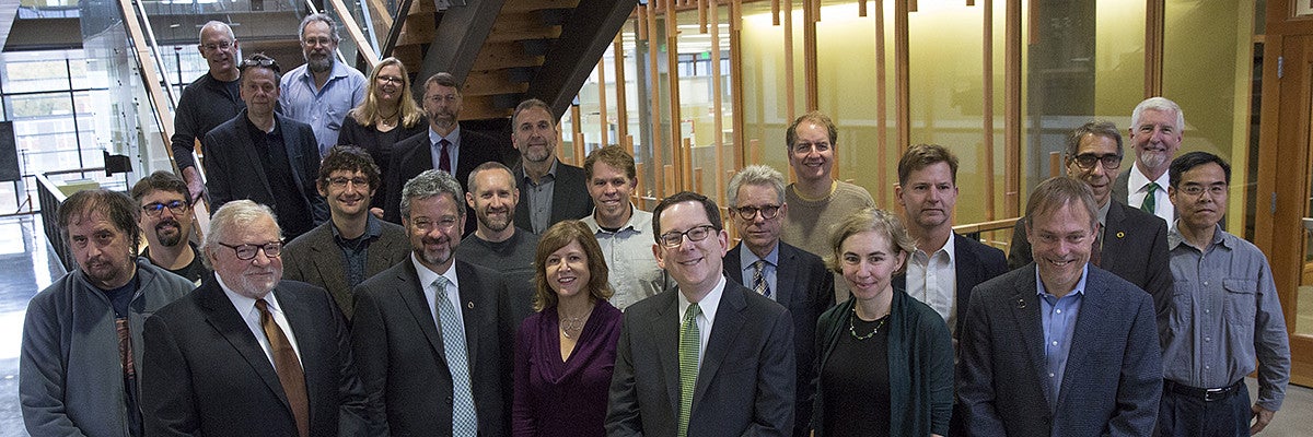 Group photo of faculty members with President Michael Schill and Board of Trustees Chair Chuck Lillis