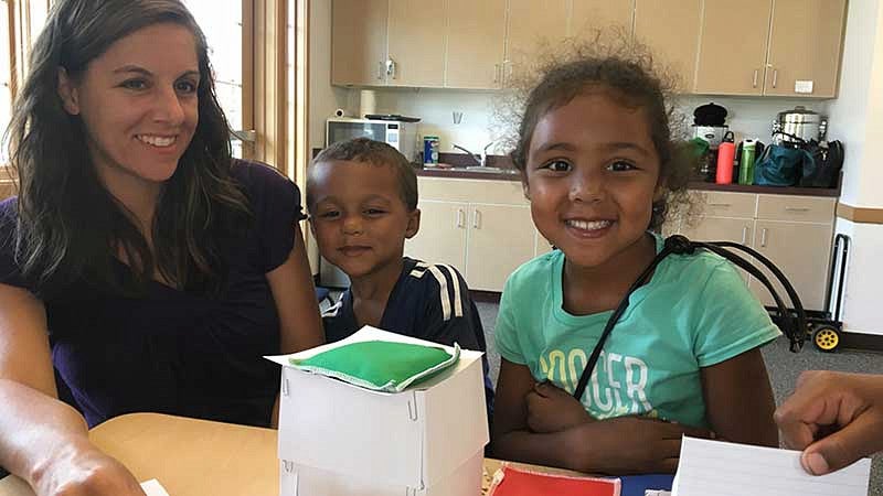 Family working on a museum kit