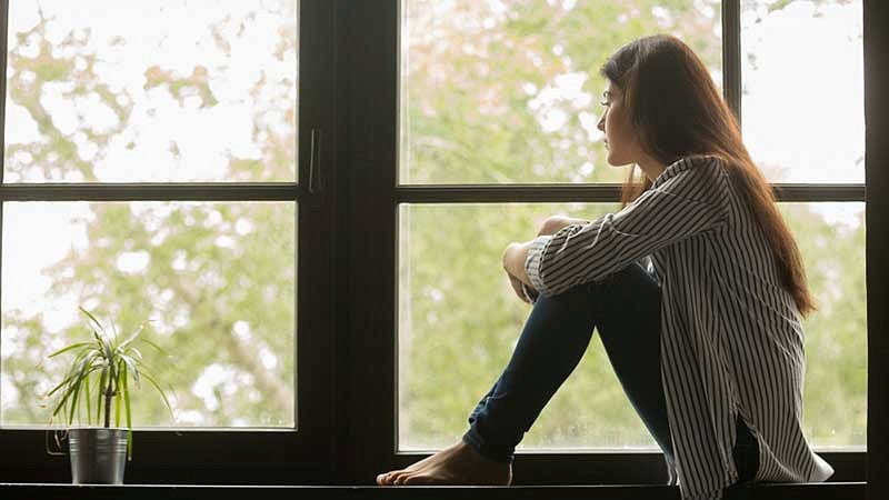 Woman staring out window