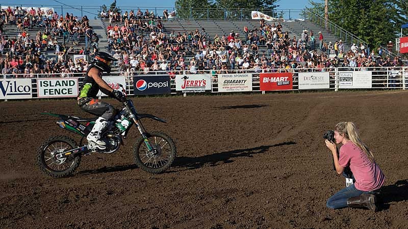 Rhianna Gelhart photographing a man on a dirt bike Rhianna Gelhart photographing a man on a dirt bike
