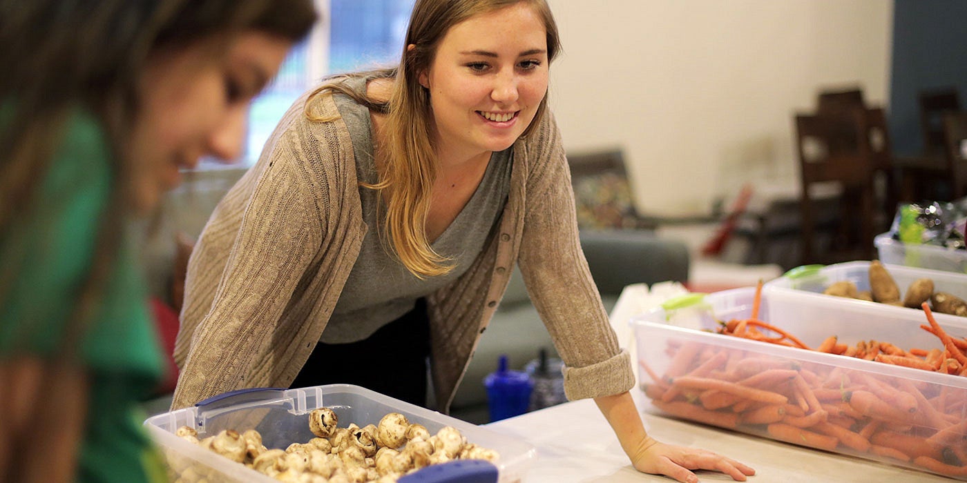 Kiara Kashuba preparing food with Cornerstone Community Housing in partnership with Food for Lane County at Willamette Gardens 