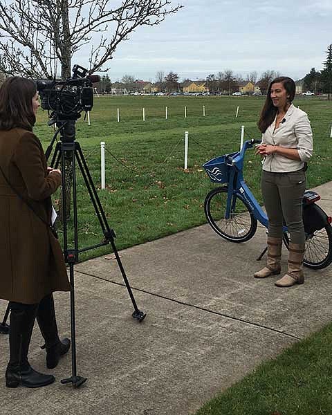 A student in AHPR being inteviewed with a PeaceHealth Rides bike