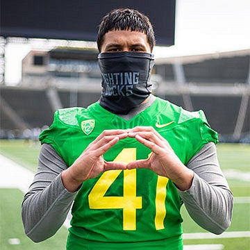 Isaac Slade-Matautia wearing a mask and throwing the O