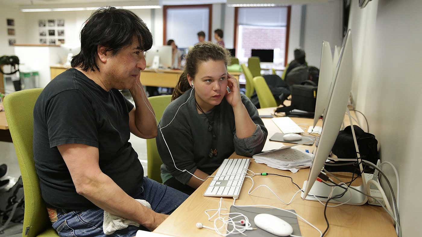 Juan Camacho at a computer with headphones on