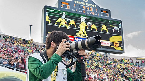 Justin Hartney shooting photos at an Oregon football game