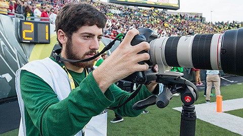 Justin Hartney shooting photos at an Oregon football game