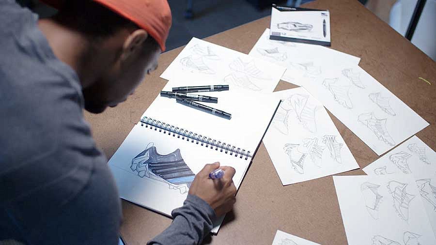 Kodi Whitfield sketching athletic shoe designs