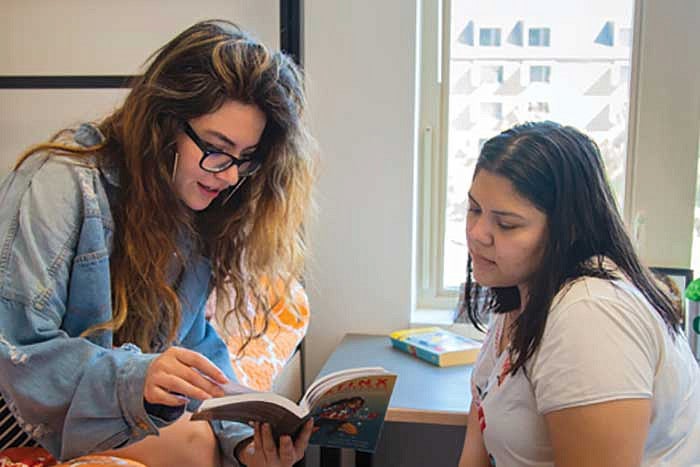 Two students talking in a residence hall room