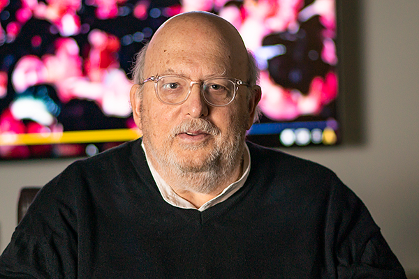 portrait of Mitchell Block in front of a colorful screen