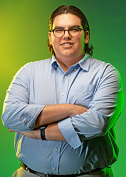 Nathan Torres pictured in front of a vivid green background