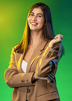 Noor Abu Rabie pictured in front of a vivid green background