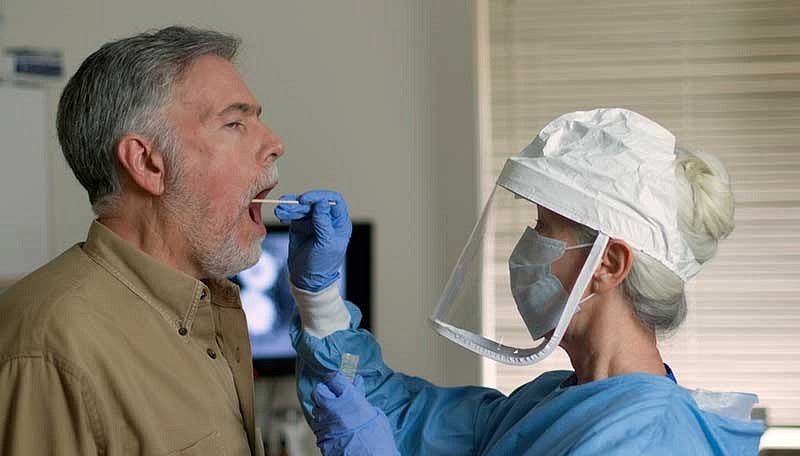 Health care worker taking COVID-19 swab