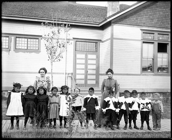 Students and teachers at Warm Springs School, 1901. Reservation schools of this era operated on racist principles aimed at eradicating Indigenous languages and cultures. Courtesy of Oregon Digital. Students and teachers at Warm Springs School, 1901. Reservation schools of this era operated on racist principles aimed at eradicating Indigenous languages and cultures. Courtesy of Oregon Digital.