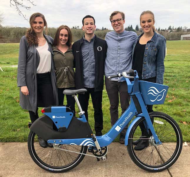 Members of AHPR with a PeaceHealth bike