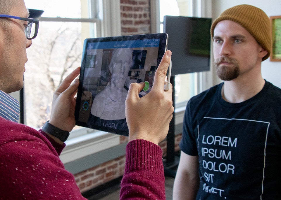 Professor Maxwell Foxman scans a student’s face