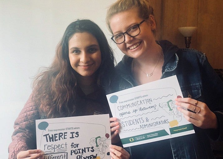 Two students with freedom of expression signs