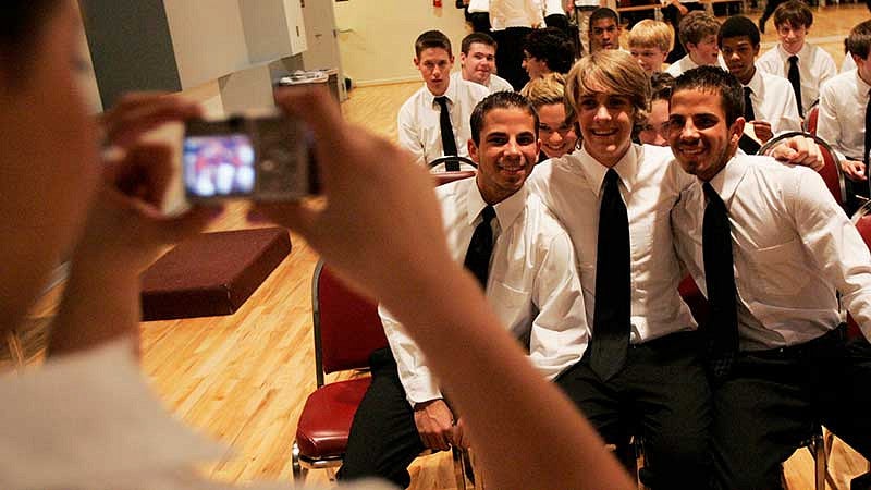 Students getting their photo taken after the final performance of the Stangeland Family Youth Choral Academy 