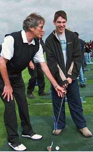 Ron Plath instructs Mark Stewart, a student at the Washington State School for the Blind, during the 2010 Oregon Lions Sight and Hearing Foundation golf tournament at the Reserve Vineyards course in Aloha. Photograph by Adrienne Fernandez