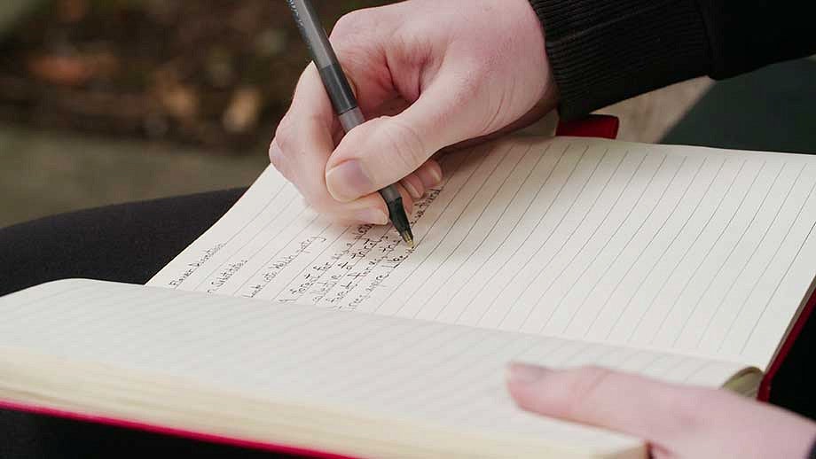 Sarah Hovet writing in her notebook