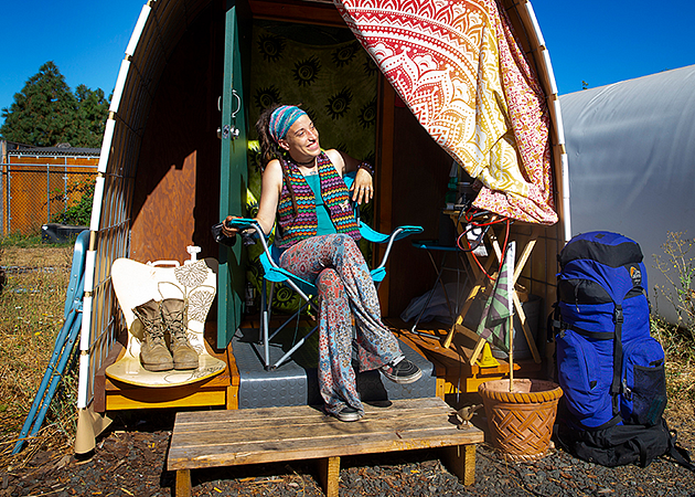 Jourdan Horton outside a Conestoga hut temporary shelter