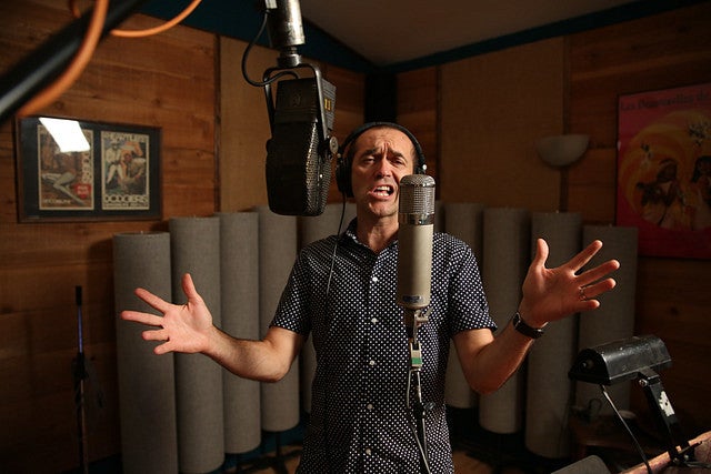 Steve Perry in the recording studio singing at a microphone