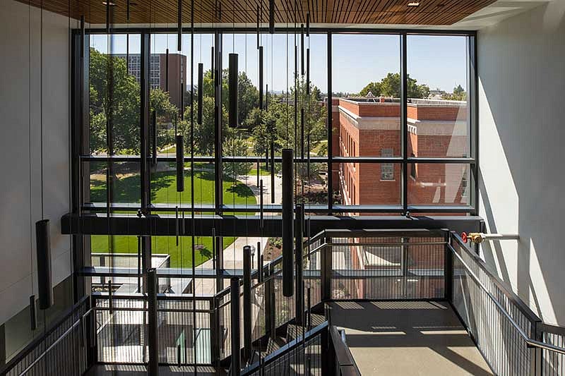 A view through the window looking at Chapman Hall from inside Tykeson Hall