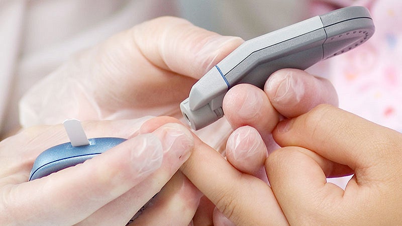 Young child in hospital getting a blood test with doctor