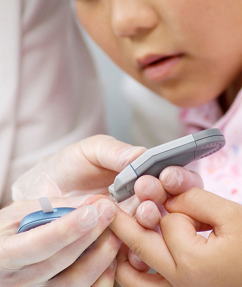 Young child in hospital getting a blood test with doctor