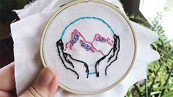 Close up of a mountain being embroidered