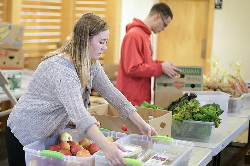 Kiara Kashuba preparing food with Cornerstone Community Housing in partnership with Food for Lane County at Willamette Gardens 