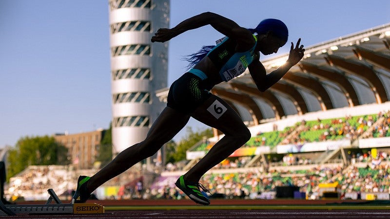 Sprinter in starting blocks in silhouette