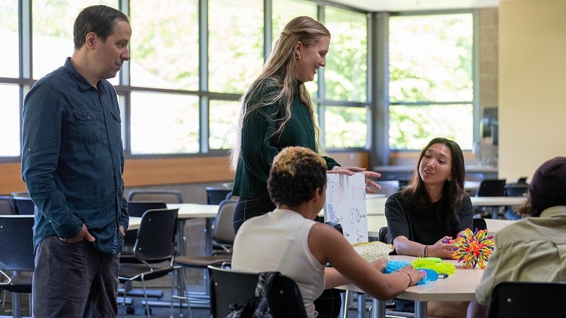 Ballmer Institute faculty, staff, and students with middle school students in a classroom setting