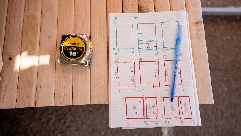 A sketch on a table next to a tape measure for the "Everyone's village" for the Bruton Design Intensive