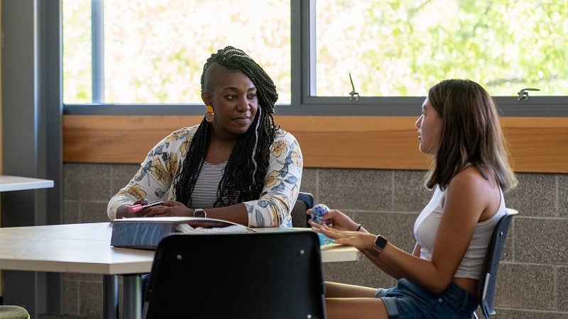 Miriam White-Pedeaux, Ballmer Institute clinical faculty member, listens to a middle-school student