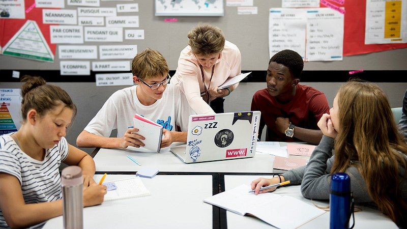 Teacher helping student in a classroom