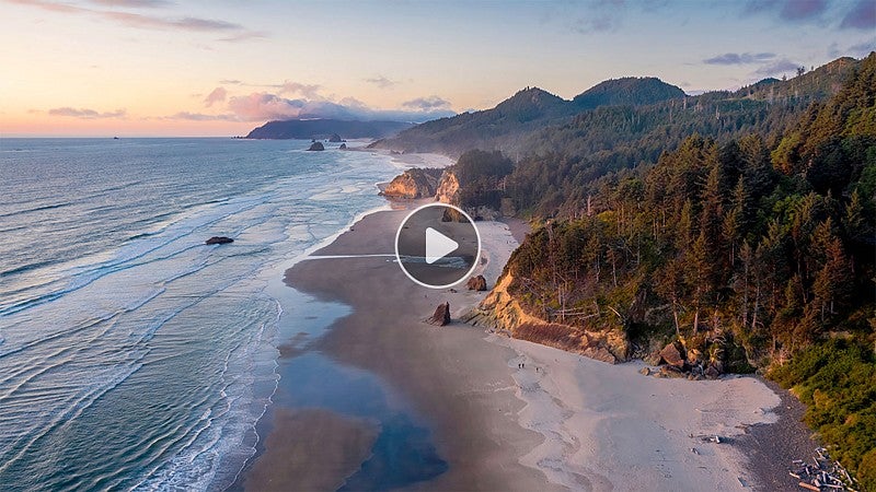 An aerial view of the Oregon coastline with beach and forest